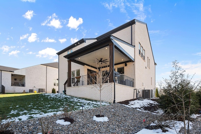 exterior space with cooling unit, a lawn, and ceiling fan