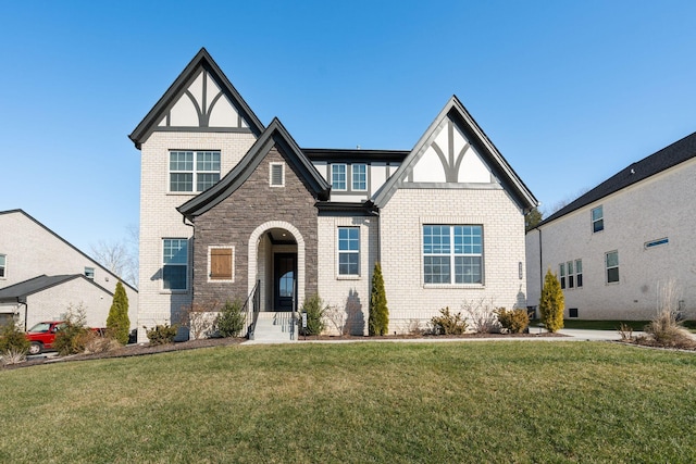 tudor home with a front lawn