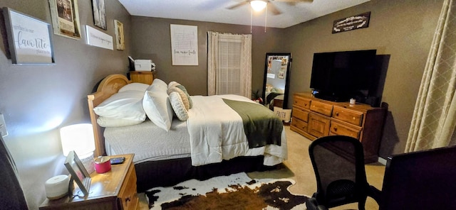 bedroom featuring a ceiling fan and light carpet