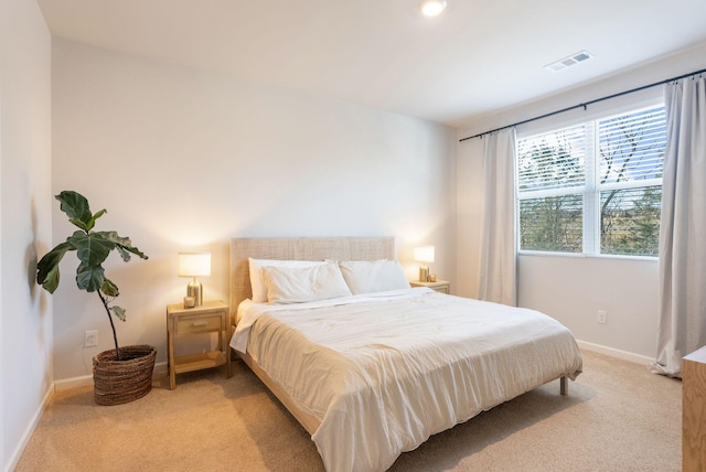 bedroom with light colored carpet