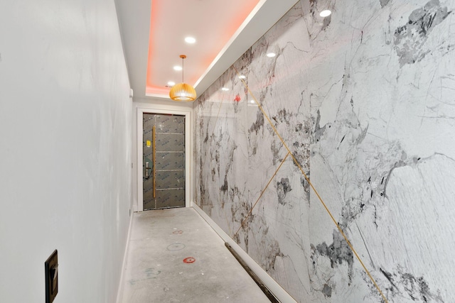 hallway featuring a raised ceiling