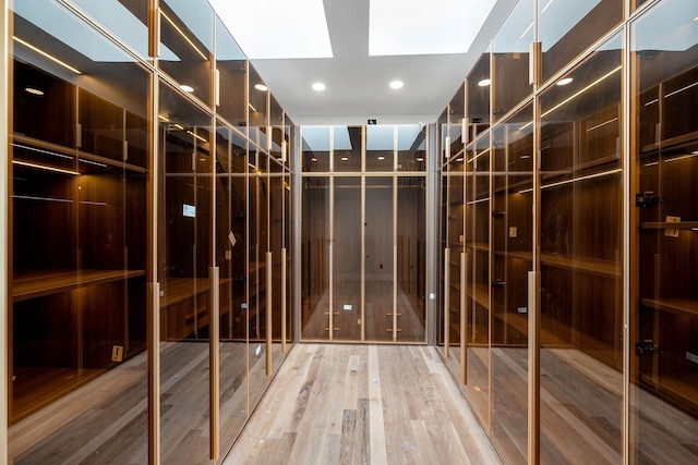 wine cellar featuring hardwood / wood-style flooring and a skylight