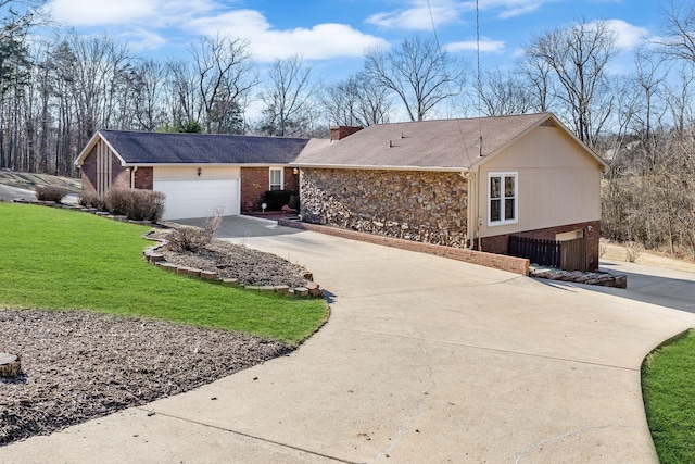 view of side of property featuring a yard and a garage