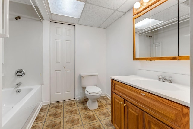 full bathroom featuring vanity, a paneled ceiling, bathtub / shower combination, and toilet