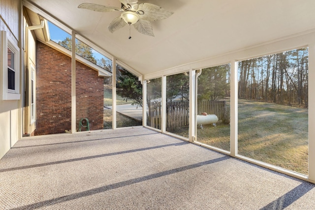 unfurnished sunroom featuring ceiling fan and a healthy amount of sunlight