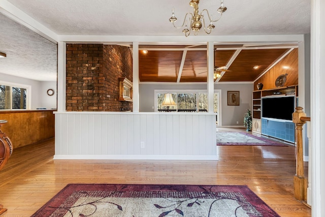 kitchen with wood ceiling, built in features, wood-type flooring, a textured ceiling, and vaulted ceiling