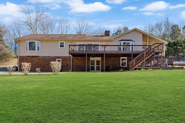 back of house with a deck and a lawn