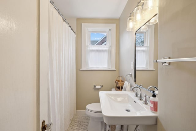 bathroom featuring tile patterned flooring, sink, and toilet