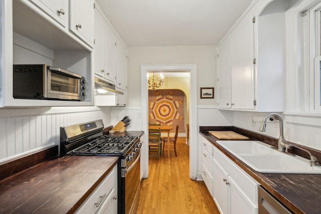 kitchen with white cabinetry, stainless steel appliances, light hardwood / wood-style floors, and sink