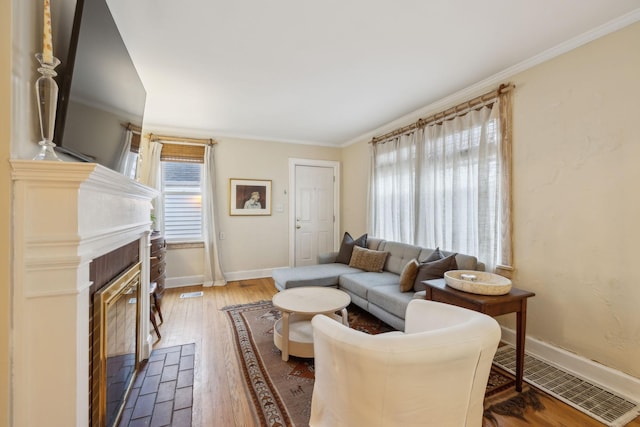 living room with ornamental molding and wood-type flooring