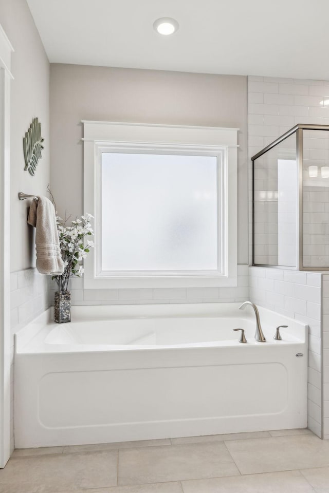 bathroom with shower with separate bathtub