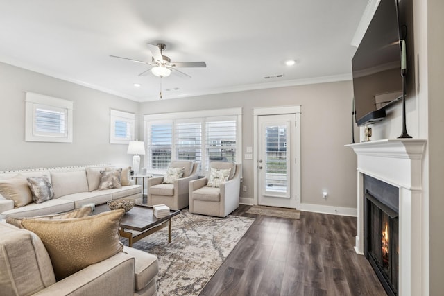 living room with crown molding, ceiling fan, and dark hardwood / wood-style flooring