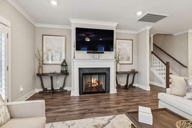 living room featuring dark wood-type flooring and ornamental molding