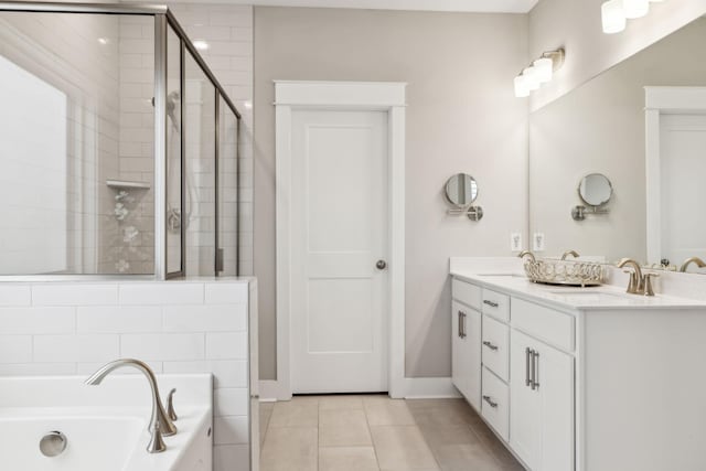 bathroom featuring tile patterned floors, vanity, and shower with separate bathtub