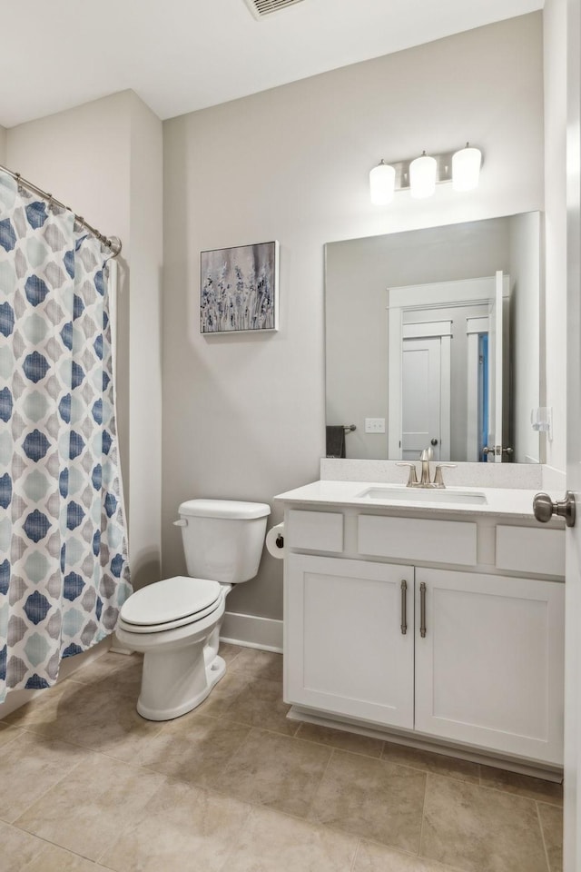 bathroom with a shower with curtain, tile patterned floors, vanity, and toilet