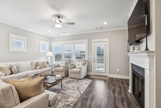 living room with crown molding, dark hardwood / wood-style floors, and ceiling fan