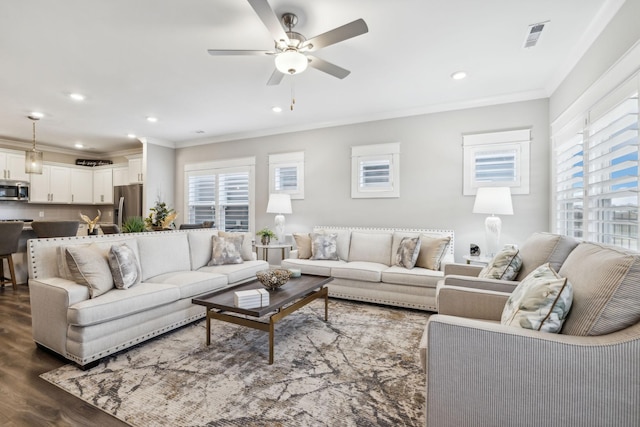 living room with ceiling fan, ornamental molding, and dark hardwood / wood-style flooring