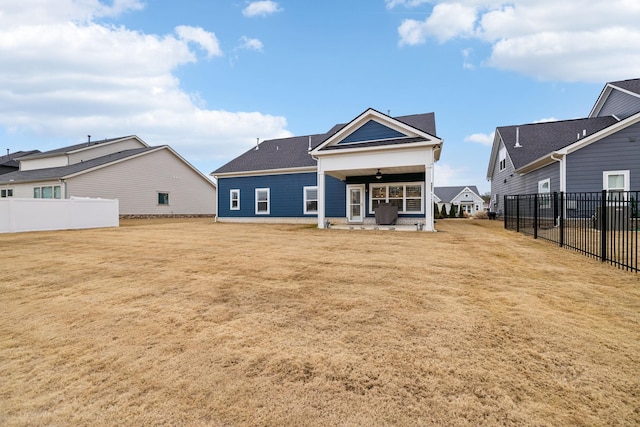 rear view of property with a patio and a lawn