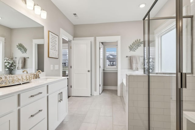 bathroom featuring vanity and plus walk in shower