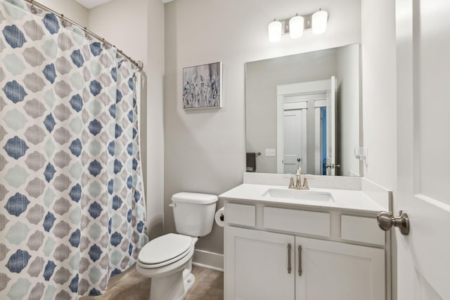 bathroom featuring vanity, a shower with shower curtain, and toilet