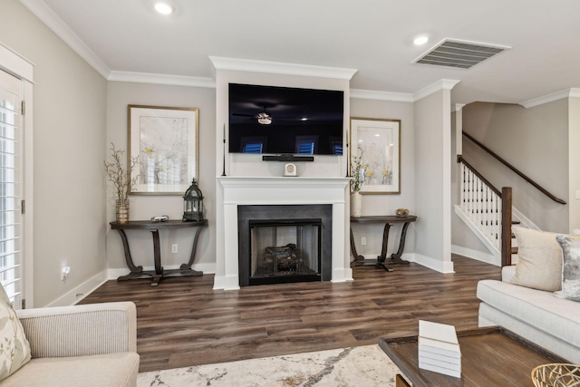 living room featuring dark hardwood / wood-style flooring and ornamental molding