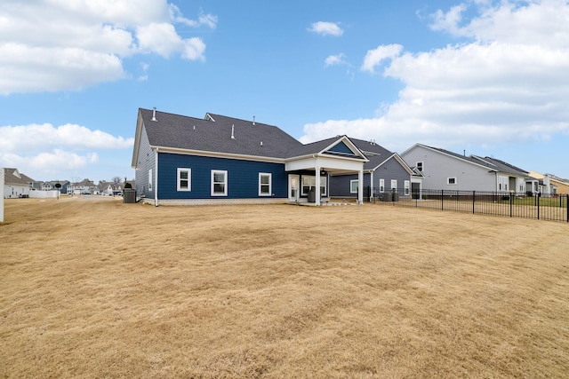 back of property with a yard and cooling unit