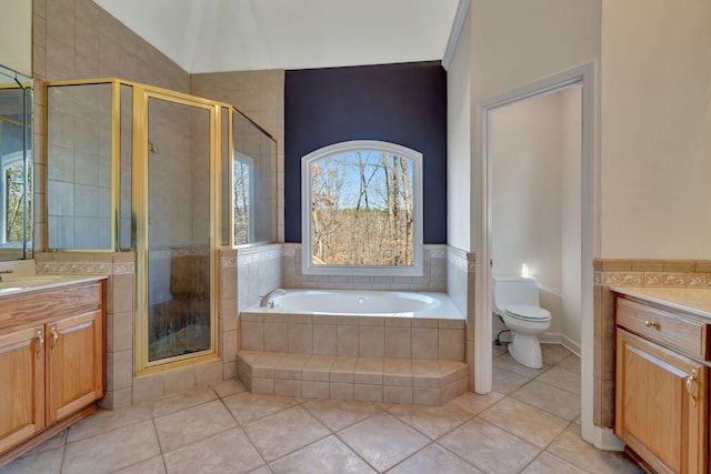 full bathroom featuring vanity, tile patterned floors, shower with separate bathtub, and toilet