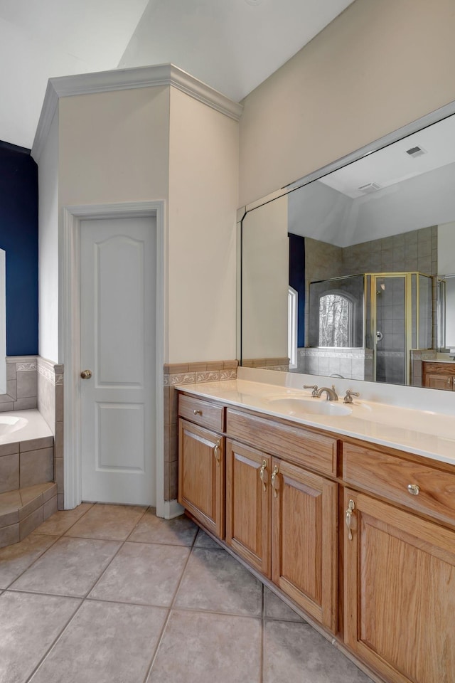 bathroom featuring vanity, shower with separate bathtub, and tile patterned flooring