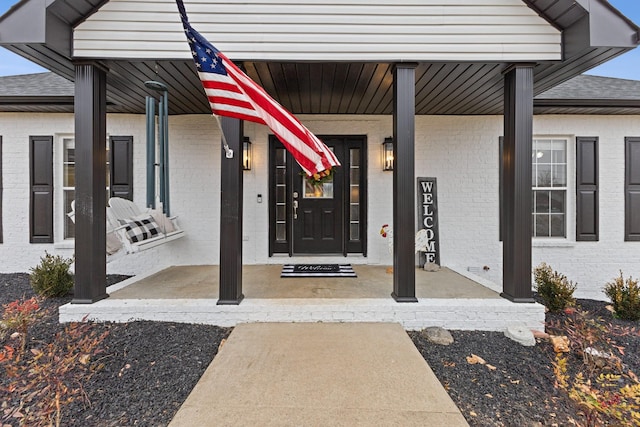 doorway to property with covered porch