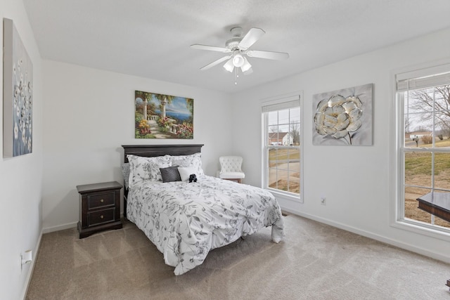 bedroom with multiple windows, carpet flooring, and ceiling fan