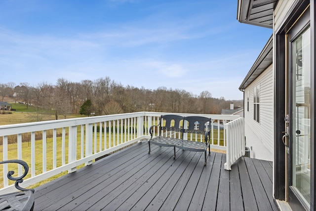 wooden terrace featuring a yard