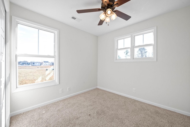 spare room with carpet floors and ceiling fan