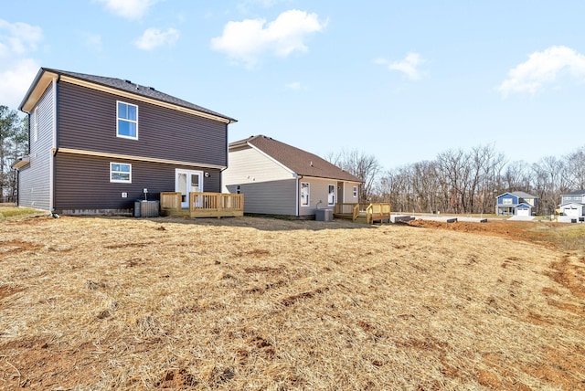 back of house featuring central AC, a deck, and french doors