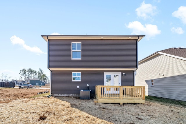 rear view of house with french doors, a deck, and central air condition unit