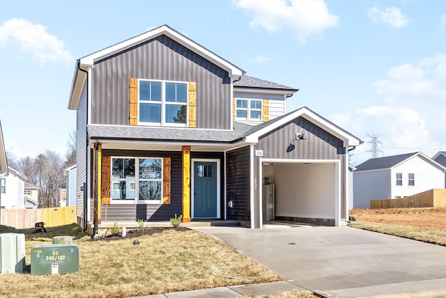 view of front of home with a garage, a front yard, and water heater