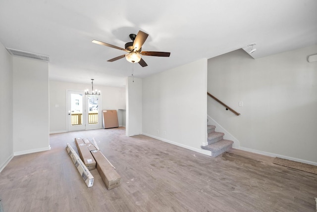 unfurnished living room with hardwood / wood-style flooring and ceiling fan with notable chandelier