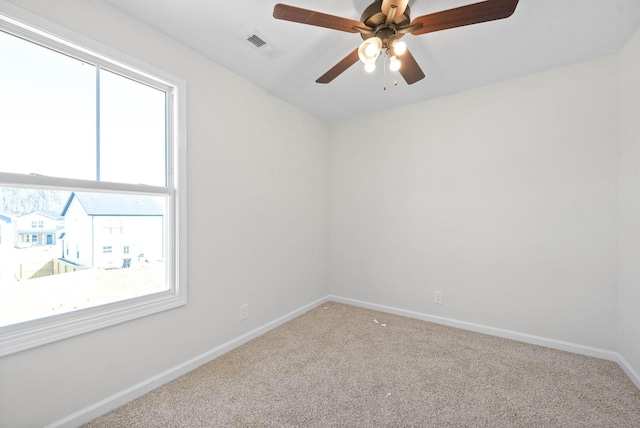 unfurnished room featuring ceiling fan and carpet flooring