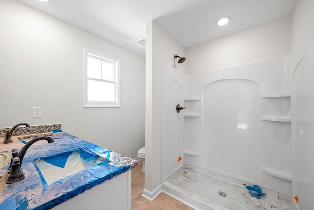 bathroom with vanity, toilet, and walk in shower