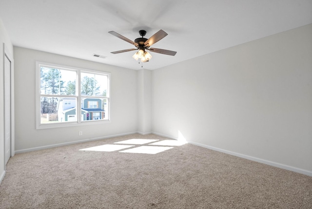 carpeted empty room with ceiling fan