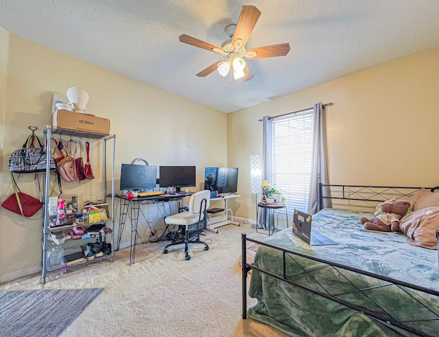 carpeted bedroom featuring ceiling fan and a textured ceiling