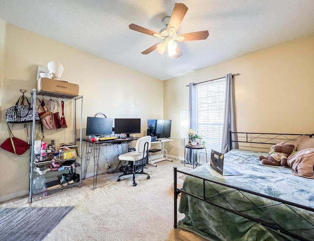 bedroom featuring ceiling fan, carpet, and a textured ceiling