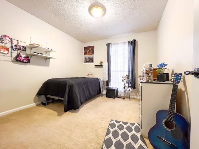 carpeted bedroom featuring a textured ceiling