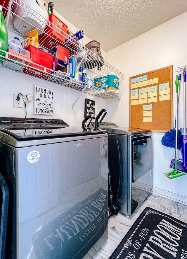 washroom featuring washer and dryer and a textured ceiling