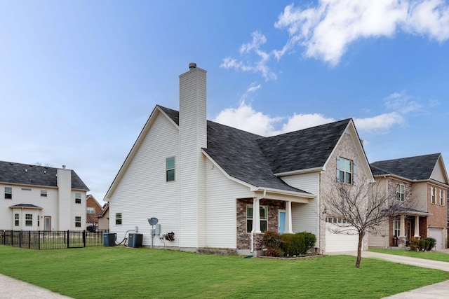 view of home's exterior with a garage, a lawn, and central air condition unit