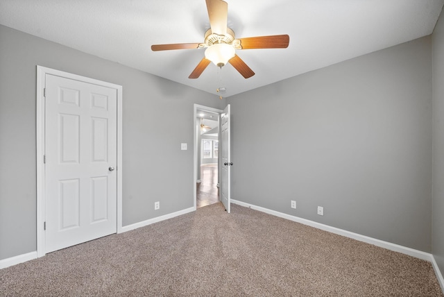 unfurnished bedroom featuring carpet floors and ceiling fan