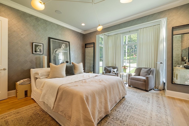 bedroom featuring ornamental molding and light hardwood / wood-style floors