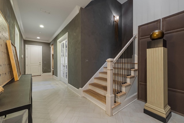 stairway featuring parquet floors and crown molding