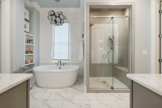 bathroom with vanity, shower with separate bathtub, and a chandelier