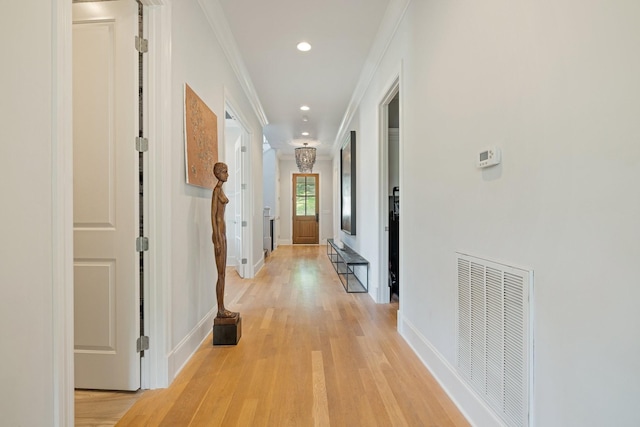 corridor featuring ornamental molding and light wood-type flooring