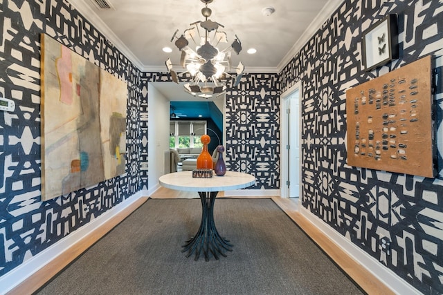 interior space featuring wood-type flooring, ornamental molding, and a chandelier